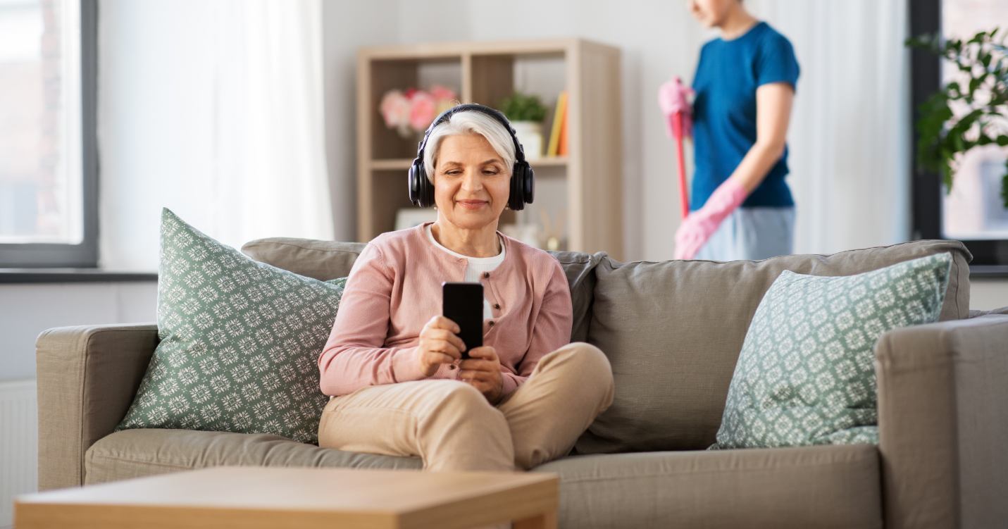 A person sitting on a couch wearing headphones Description automatically generated